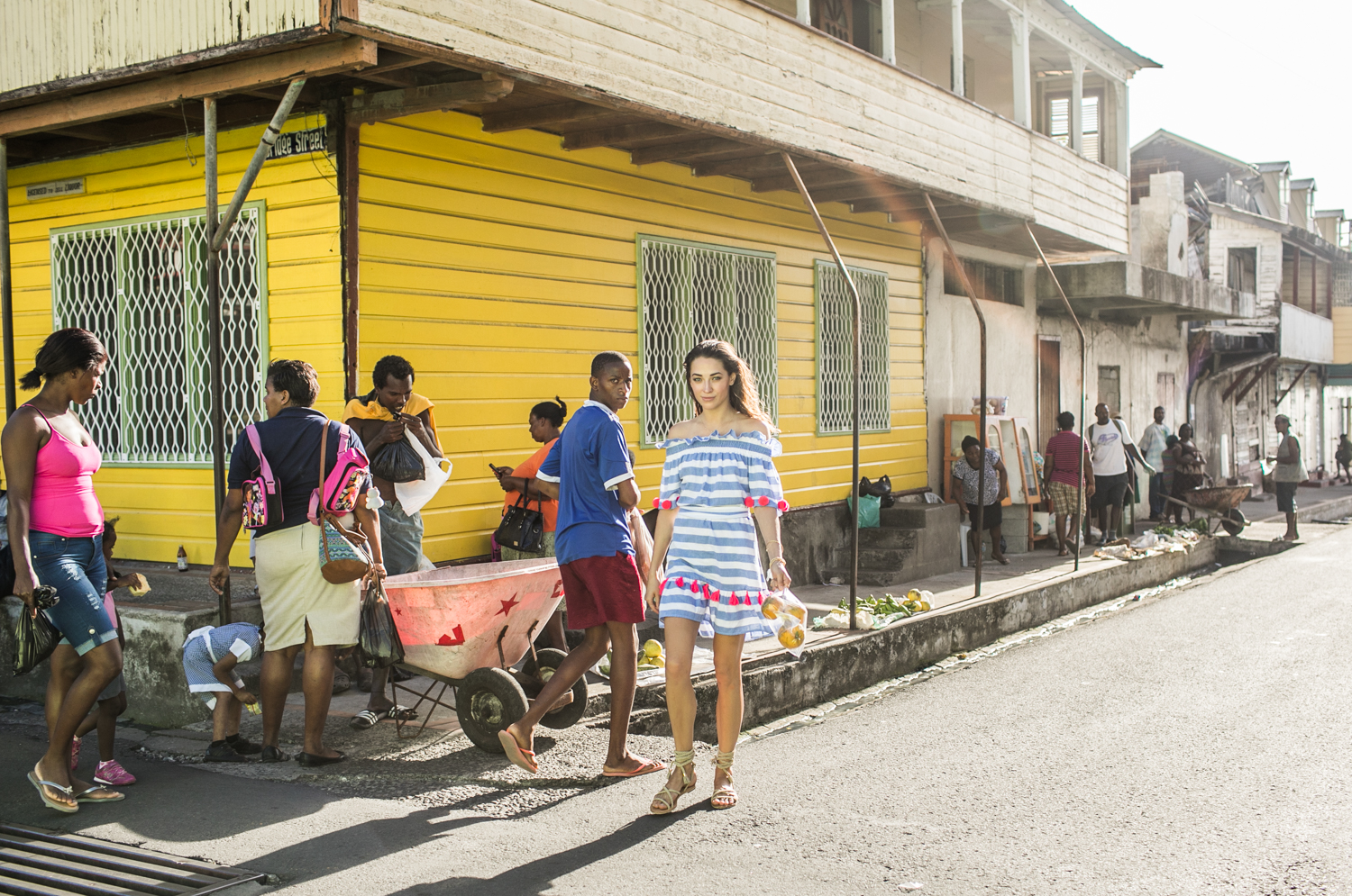 Russian model and blogger Xenia and photographer Samuel Black exploring St Lucia. Xenia wears Sundress official in local fishermen villages.